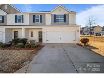 Two-story townhome with attached garage and landscaping at 8138 Paw Club Dr, Charlotte, NC 28214