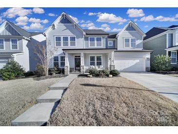 Two-story house with gray siding, stone accents, and a front porch at 925 Gray Hook Dr, Fort Mill, SC 29708