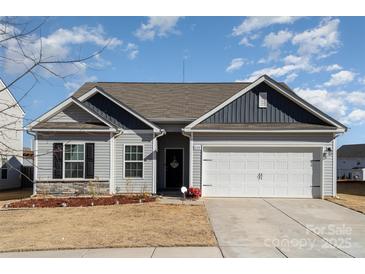 Gray siding house with a two-car garage and landscaping at 1120 Culver Spring Way, Charlotte, NC 28215