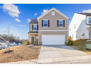 Two-story house with neutral siding, attached garage, and landscaping at 128 Mooring Dr, Statesville, NC 28677