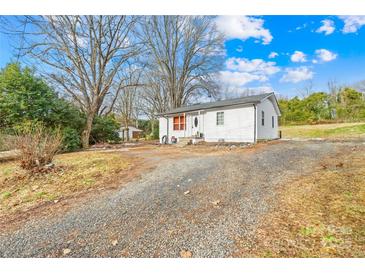 Front view of a white single story home with a gravel driveway at 1449 Cherryville Rd, Shelby, NC 28150