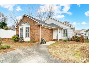 Brick and white sided home with a small yard and driveway at 1749 Ridgefield Ct, Rock Hill, SC 29732