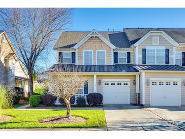 Two-story townhome with neutral siding, attached garage, and landscaping at 318 Rose Garden Ct, Rock Hill, SC 29732