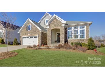 Attractive two-story home with stone exterior and landscaping at 45528 Misty Bluff Dr, Charlotte, NC 28278