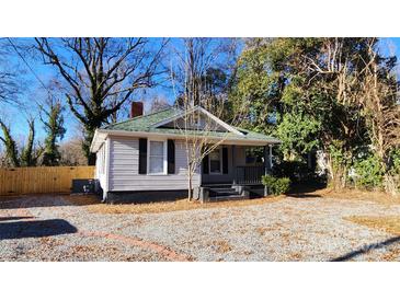 Charming house with gray siding and a gravel driveway at 830 Richard Ave, Kannapolis, NC 28081