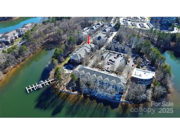 Aerial view of lakefront property with condo building and parking at 921 Northeast Dr, Davidson, NC 28036