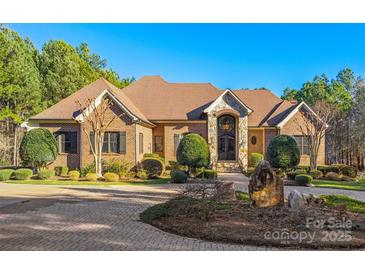 Stunning brick home featuring mature landscaping and a paver driveway leading to the grand entrance at 1024 Adkins Rd, York, SC 29745