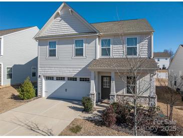 Two-story house with gray siding, stone accents, and a two-car garage at 120 Fern Ln, Troutman, NC 28166