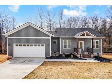 Charming single-Gathering home features a gray exterior, attached garage, and inviting front porch at 122 Stockbridge Ln, Statesville, NC 28625