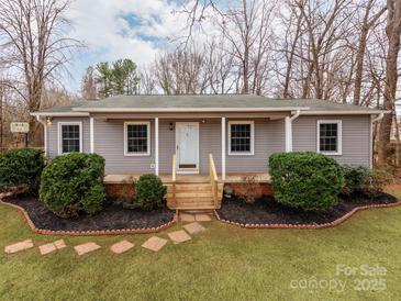 Gray house with a wooden porch and landscaping at 205 Mae Rd, Salisbury, NC 28146