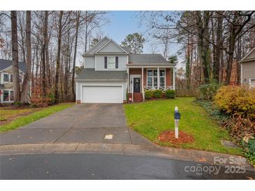 Two-story house with gray siding, brick accents, and a front porch at 3801 Melshire Ln, Charlotte, NC 28269