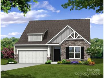 Craftsman style home with stone accents and a two-car garage at 4003 Grace Pointe Dr # 99, Wesley Chapel, NC 28079