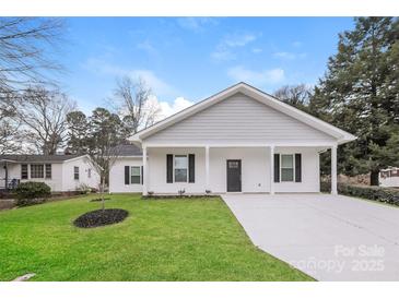 Newly constructed home with gray siding, white trim, and a spacious driveway at 13331 Central Ave, Huntersville, NC 28078