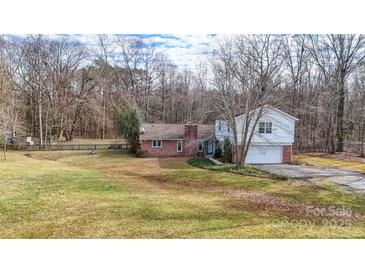 Brick ranch house with attached garage and large backyard at 4621 Wolf Pond Rd, Monroe, NC 28112