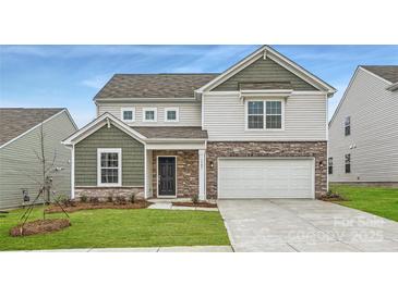 Charming two-story home with stone accents, green lawn, and attached two car garage at 1187 Blackburn Cir, Edgemoor, SC 29712