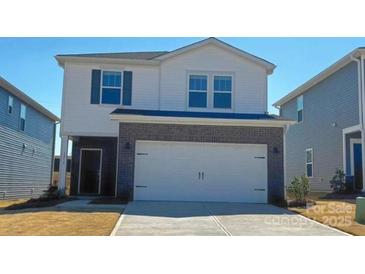 Two-story home featuring white siding and a two-car garage with a brick facade detail at 1212 31St Ne St, Conover, NC 28613