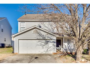 Two-story house with attached garage and mature trees in the front yard at 1309 Winding Branch Ct, Charlotte, NC 28216