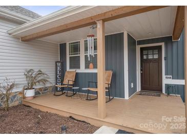 Inviting front porch with rocking chairs, perfect for relaxing at 1544 Farmington Hills Dr, Conover, NC 28613