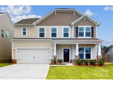 Two-story house with beige and brown siding, a two-car garage, and landscaping at 2125 Clifton Rd, Sherrills Ford, NC 28673