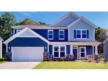 Two-story home with blue siding, white trim, and a landscaped lawn at 242 Winford Rd, Troutman, NC 28116