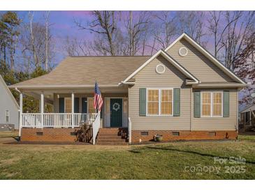 Charming one-story house with a front porch and landscaped yard at 409 Chinaberry Dr, China Grove, NC 28023