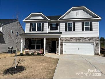 Two-story house with gray siding, stone accents, and a two-car garage at 4479 Dover Ct, Denver, NC 28037