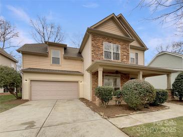 Two-story house with stone accents and a two-car garage at 5124 Craftsman Ridge Dr, Matthews, NC 28104