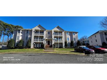 Three-story condo building with multiple units and balconies at 6127 Meadow Rose Ln, Charlotte, NC 28215