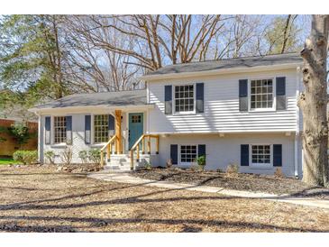 Charming two-story home featuring a light-colored brick and wood facade and a neatly landscaped front yard at 6706 Queensberry Dr, Charlotte, NC 28226