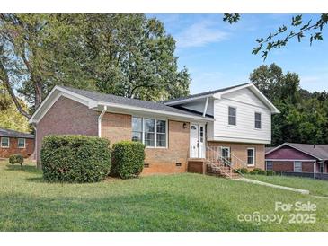 Brick ranch home with a landscaped yard and white accents at 6762 Glenmoor Dr, Charlotte, NC 28214