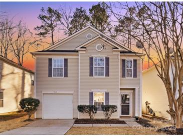 Charming two-story home features a cozy front porch, attached garage, and manicured landscaping at 7010 Sycamore Grove Ct, Charlotte, NC 28227