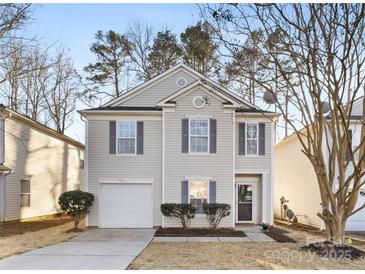 Two-story house with vinyl siding, attached garage, and landscaping at 7010 Sycamore Grove Ct, Charlotte, NC 28227