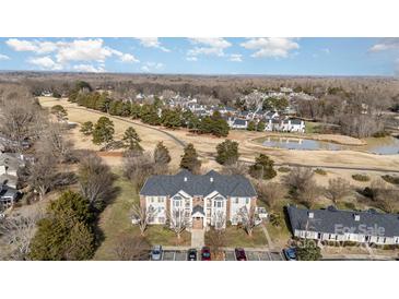 Condo building with a view of the surrounding golf course at 10240 Rose Meadow Ln # D, Charlotte, NC 28277