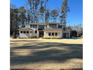 Two-story modern home with white brick exterior, gray accents, and attached garage at 109 Myers Port Way # 2, Mooresville, NC 28117