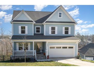 Two-story light blue house with white accents and a double garage at 12060 Mariners Cove Ct, Lancaster, SC 29720