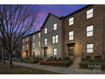 Three-story townhome with gray and brick exterior, and a modern design at 1554 Kee Ct, Charlotte, NC 28203