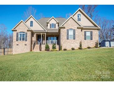 Brick house with a large front yard and attached garage at 162 Ravencrest Dr, Statesville, NC 28625