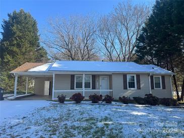 Ranch style home with snow covered lawn at 219 W Edison Dr, Statesville, NC 28625