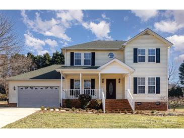 Two-story house with a gray garage door and brick steps leading to the porch at 2241 Londonderry Dr, Gastonia, NC 28056