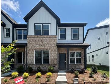 Charming townhome featuring a brick and siding facade, complemented by manicured landscaping and a welcoming entryway at 3113 Beacon Heights Rd, Indian Land, SC 29707