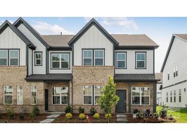 Inviting townhome with brick and siding, featuring a well-manicured lawn and charming curb appeal at 3113 Beacon Heights Rd, Indian Land, SC 29707