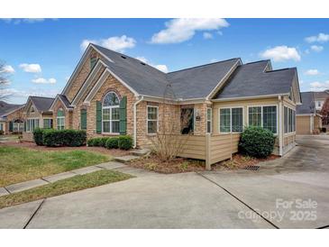 Stone and shingle exterior of charming ranch home with landscaping at 4829 Boomerang Way, Charlotte, NC 28269