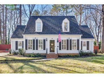 Charming two-story home featuring a well-maintained yard and classic architectural details at 7832 Winterset Dr, Charlotte, NC 28270