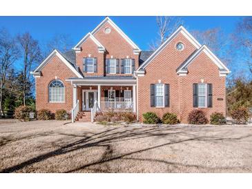 Brick two-story house with a white porch and attached two-car garage at 11925 Lawings Corner Dr, Huntersville, NC 28078