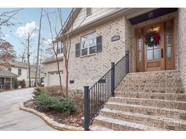 Brick home with a charming front porch and landscaping at 12 Tanglewood Rd, Clover, SC 29710