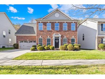 Brick two-story house with attached garage and landscaping at 13026 Serenity St, Huntersville, NC 28078