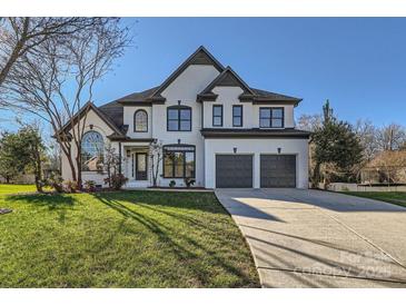 Two story home with white exterior, gray accents, and three car garage at 18038 Greyfield Gln, Fort Mill, SC 29707