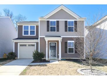 Two-story house featuring a neutral color scheme and a neatly landscaped yard at 1812 Hooper Ct, Charlotte, NC 28212