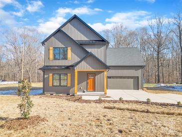 Two-story modern farmhouse with gray siding, orange door and wood accents at 591 Shiloh Rd, Statesville, NC 28677