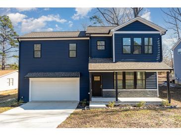 Charming two-story home with a white garage and welcoming front porch at 619 Norland Ave, Kannapolis, NC 28083